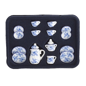 May include: A blue and white porcelain tea set in a black foam tray. The set includes a teapot, creamer, sugar bowl, four cups, and four saucers.