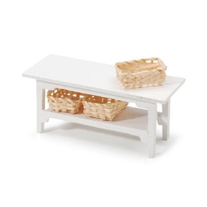 May include: White wooden table with two shelves and three woven baskets. The table is a miniature piece of furniture.