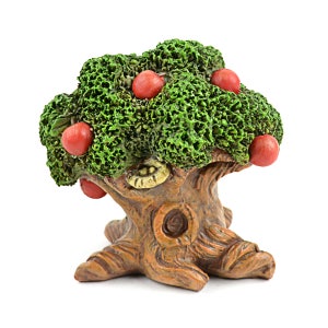 May include: A small, ceramic tree with a green, textured canopy and a brown, gnarled trunk. The tree is decorated with red, round fruit.