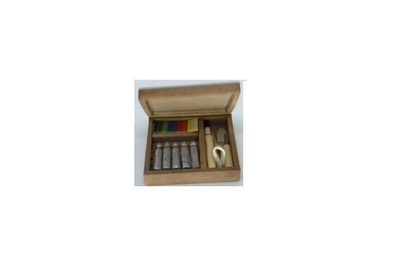 May include: A wooden box with a hinged lid, containing six small silver tubes, a small wooden tool, and a small white tool. The box is open and the contents are visible.