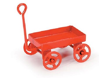May include: A red metal toy wagon with a handle and four wheels. The wagon is small and would be suitable for a child's play.