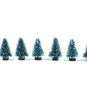May include: Set of seven miniature artificial Christmas trees, each with a green and blue flocked finish and a black base.
