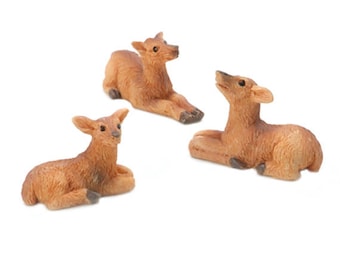 May include: Three small, brown, ceramic deer figurines. The deer are in various poses, including lying down and looking up.
