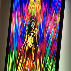 May include: A movie poster for Wonder Woman 1984 featuring Wonder Woman in her golden armor standing in front of a colorful, abstract background. The text "JUNE 5, 2020" is at the bottom of the poster.