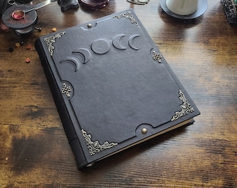 Black Moon phases leather 3-ring binder by Velimira.  Aged pages,  letter size