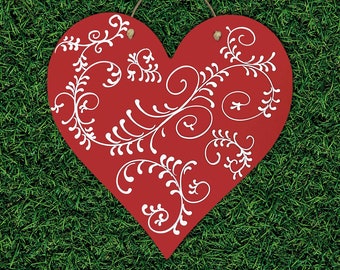 May include: Red heart-shaped wooden sign with a white floral design. The sign has a string loop for hanging.