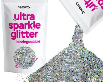 May include: A white resealable bag of silver star-shaped glitter labeled "ultra sparkle glitter biodegradable" with the brand name "hemway" printed on the bag. The bag is open and pouring out the glitter onto a white surface.