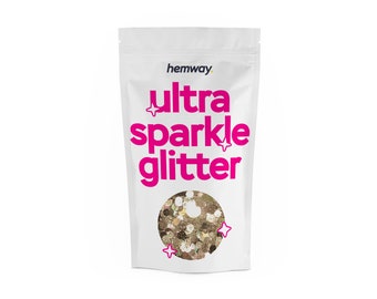 May include: A white resealable pouch with the text "hemway ultra sparkle glitter" in pink lettering. The pouch contains gold glitter.