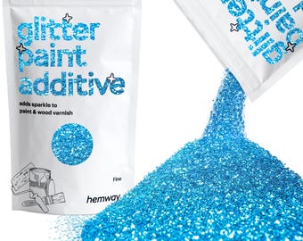 May include: White bag of blue glitter paint additive with the text "glitter paint additive" and "adds sparkle to paint & wood varnish." Fine glitter is pouring out of a second bag, creating a large pile of glitter.