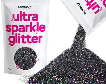 May include: A bag of black ultra sparkle glitter, pouring out onto a white surface. The bag is labeled "hemway ultra sparkle glitter" and "fine".
