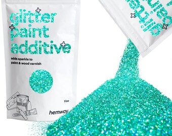 May include: A bag of fine turquoise glitter paint additive. The bag is white with black text that reads "glitter paint additive" and "adds sparkle to paint & wood varnish". The bag is open and pouring out the glitter onto a white surface.