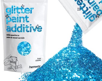 May include: White bag of blue glitter paint additive. The bag reads "glitter paint additive" and "adds sparkle to paint & wood varnish." Extra chunky glitter is pouring out of a second bag, creating a large pile of blue glitter.