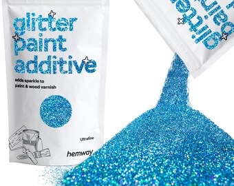 May include: White pouch of glitter paint additive with blue text and a blue glitter circle. The text reads "glitter paint additive" and "adds sparkle to paint & wood varnish." A pile of blue glitter pours from a similar pouch.