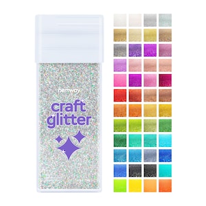 May include: A clear plastic container filled with iridescent glitter. The container has a white lid and the text "hermway craft glitter" printed on the front. A colour chart of 36 different glitter colours is shown to the right of the container.