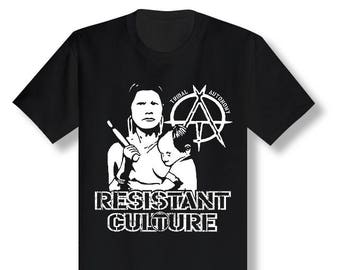 May include: Black t-shirt with a white graphic of a woman holding a child. The graphic includes the text "Tribal Autonomy" and an anarchy symbol. The text "Resistant Culture" is below the graphic.
