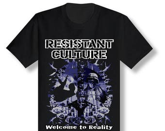 May include: Black t-shirt with a graphic design featuring a peace sign with a blue and white image of a person wearing a helmet and a crowd of people. The text "Resistant Culture" is above the graphic and "Welcome to Reality" is below the graphic.