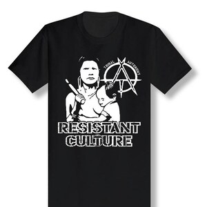 May include: Black t-shirt with a white graphic of a woman holding a child. The graphic includes the text "Tribal Autonomy" and an anarchy symbol. The text "Resistant Culture" is below the graphic.