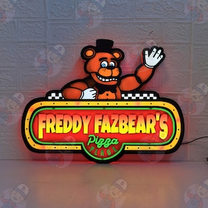 May include: A wall-mounted LED sign featuring a cartoon brown bear character wearing a black top hat and bow tie. The sign displays the text "FREDDY FAZBEAR'S Pizza PLACE" in yellow and green lettering against a red background with a black border.