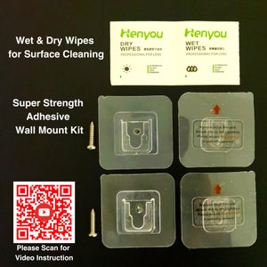 May include: A set of four clear plastic wall mount kits with adhesive backing. Each kit includes a screw and a small plastic hook. The kits are designed to be used with a lightbox. The image also includes two packages of wet and dry wipes for cleaning lenses, labeled "Henyou".