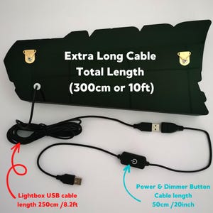 May include: Black lightbox with a long USB cable and a dimmer switch. The cable is 10 feet long and has a separate dimmer switch on a 20-inch cable.  "Extra Long Cable Total Length (300cm or 10ft)" is printed on the lightbox.