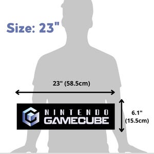 May include: A black and white Nintendo GameCube logo on a black rectangle. The rectangle is 23 inches wide and 6.1 inches tall.