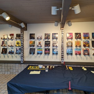 x36 sets of record holders mounted on a large basement wall. Set in a client's game room.