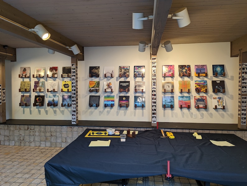 x36 sets of record holders mounted on a large basement wall. Set in a client's game room.