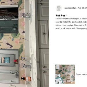 May include: A bathroom with a white vanity and two round mirrors. The walls are covered in a peel and stick wallpaper featuring a green heron and lotus flower design. The wallpaper is described as "Green Heron Asian Removable Wallpaper Chinese" in the image.