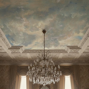May include: An ornate ceiling with a painted sky design and decorative molding. A large, crystal chandelier hangs from the center. The room has draped curtains and patterned wallpaper, creating an elegant atmosphere.