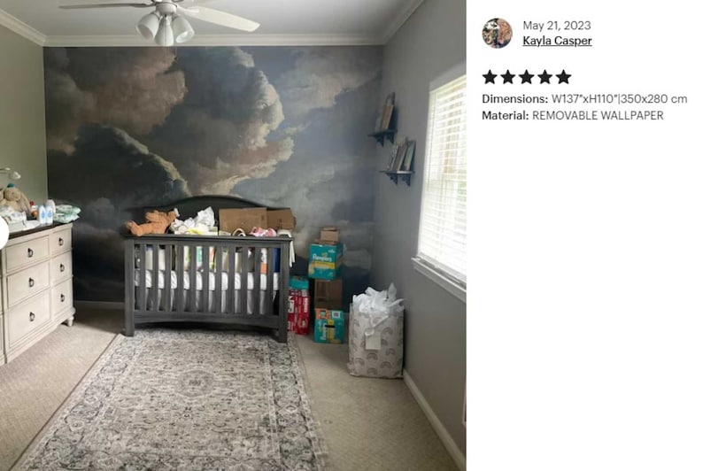 May include: A nursery room with a removable wallpaper mural depicting a cloudy sky. The wallpaper is 137 inches wide by 110 inches tall, or 350 cm by 280 cm. A crib is in the center of the room, with a white dresser to the left and a window to the right.