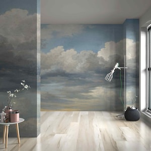 May include: A room with a mural of a cloudy sky on the walls. The room has light wood flooring, a white side table with pink vases, and a black window with blinds. A silver lamp with a wire cage shade is also present.