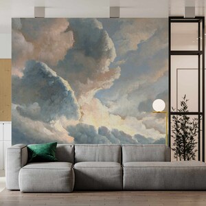 May include: A gray sectional sofa with a green throw pillow in front of a wall mural depicting a cloudy sky with shades of blue, pink, and white.
