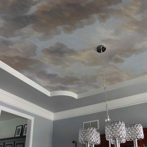 May include: A gray ceiling with a painted cloudy sky design. A silver chandelier hangs from the ceiling.