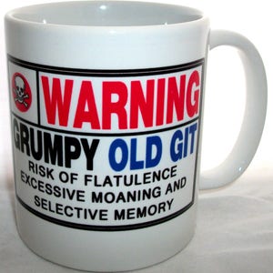 May include: White ceramic mug with a black and red warning sign that reads "WARNING GRUMPY OLD GIT RISK OF FLATULENCE EXCESSIVE MOANING AND SELECTIVE MEMORY".