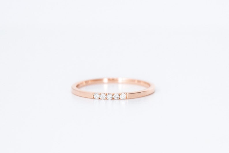 minimal thin diamond wedding band with 5 small diamonds