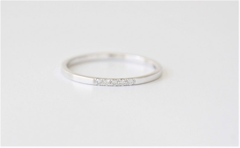 minimal thin diamond wedding band with 5 small diamonds