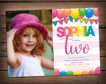 May include: A pink and white birthday invitation with a photo of a young girl wearing a pink hat. The invitation says "Sophia is turning two" with colorful balloons and flags. It includes the date, time, location, and RSVP information.