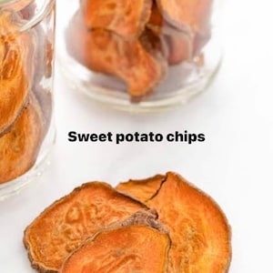 May include: Close-up of sweet potato chips, with the text "Sweet potato chips". The chips are a vibrant orange color and appear crispy. Some chips are in clear glass jars, while others are scattered on a white surface.