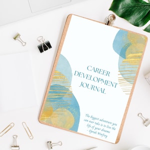 May include: A blue and gold abstract design on a white background with the text "CAREER DEVELOPMENT JOURNAL" and a quote by Oprah Winfrey: "The biggest adventure you can ever take is to live the life of your dreams."