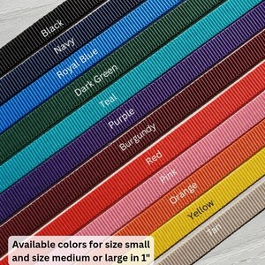 May include: A collection of twelve parallel grosgrain ribbons arranged diagonally in black, navy, royal blue, dark green, teal, purple, burgundy, red, pink, orange, yellow, and tan. Text reads: Available colors for size small and size medium or large in 1".