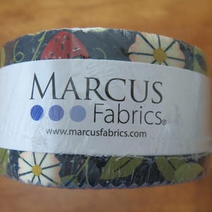 May include: A roll of fabric wrapped in clear plastic. The fabric has a dark blue background with a pattern of white daisies, green leaves, and red strawberries. The label reads "MARCUS Fabrics" with a website address.