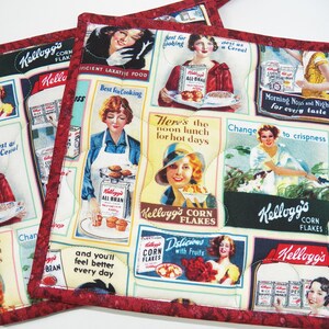 May include: Two square quilted pot holders featuring a vintage Kellogg's cereal advertisement print. The fabric displays various illustrations of people with boxes of Corn Flakes and All-Bran, including text like "Best for Cooking" and "Here's the noon lunch for hot days."