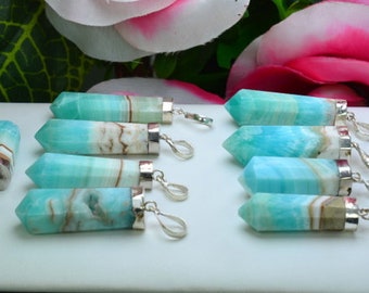 May include: A collection of gemstone pendants with a light blue and white color scheme. Each pendant has a silver-colored metal cap and a loop for a chain. The gemstones are polished and faceted, with a pointed end.