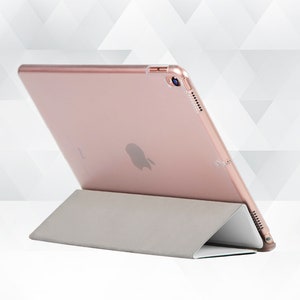 May include: A rose gold iPad case with a stand. The case is made of a hard plastic material and has a soft, microfiber lining. The stand is made of a durable plastic and folds out to provide a comfortable viewing angle.