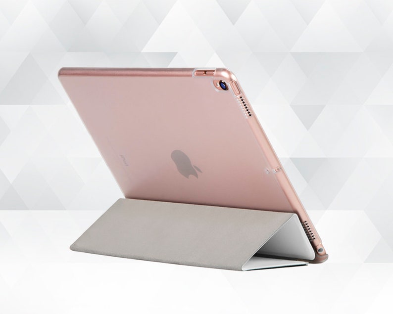 May include: A rose gold iPad case with a stand. The case is made of a hard plastic material and has a soft, microfiber lining. The stand is made of a durable plastic and folds out to provide a comfortable viewing angle.