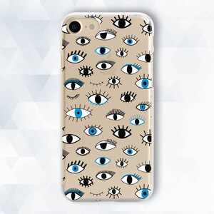May include: A clear phone case with a pattern of blue and black eyes on a beige background.