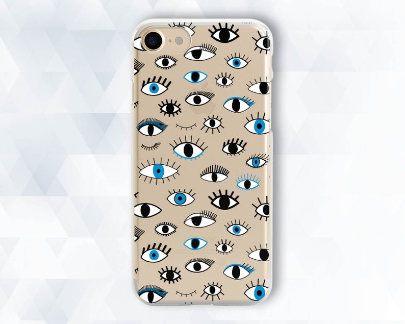 May include: A clear phone case with a pattern of blue and black eyes on a beige background.