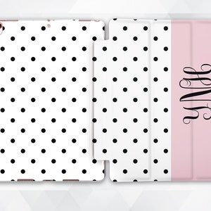 May include: A white and black polka dot iPad case with a pink flap that has the monogram "YNH" in black script.