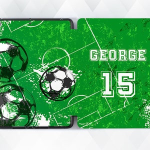 May include: Green and white iPad case with a soccer theme. The case has a green background with white soccer balls and a white soccer field. The text "GEORGE 15" is printed in white on the case.