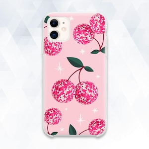 May include: Pink phone case featuring a cherry design. The cherries are made of pink and white mosaic-like patterns, with green leaves and stems. White star accents are scattered across the pink background.